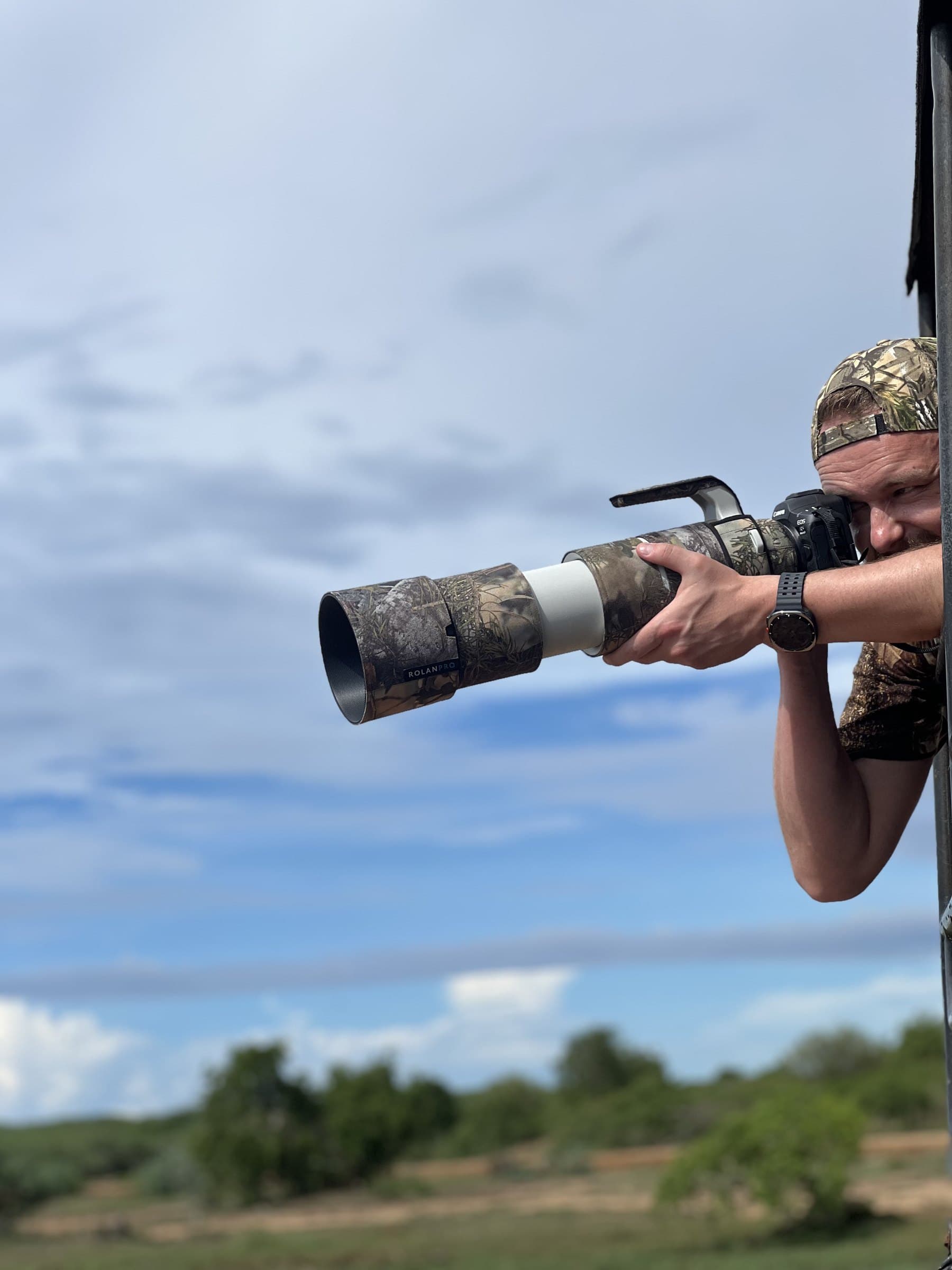 A wildlife photographer capturing the action with a telephoto lens